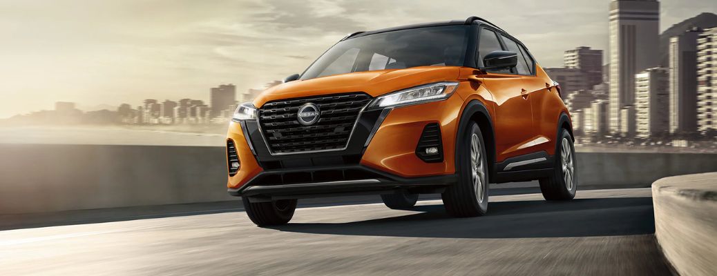 2023 Nissan Kicks Orange driving on the road