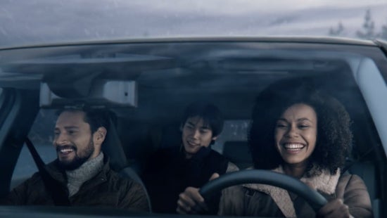 Three passengers riding in a vehicle and smiling | San Leandro Nissan in San Leandro CA